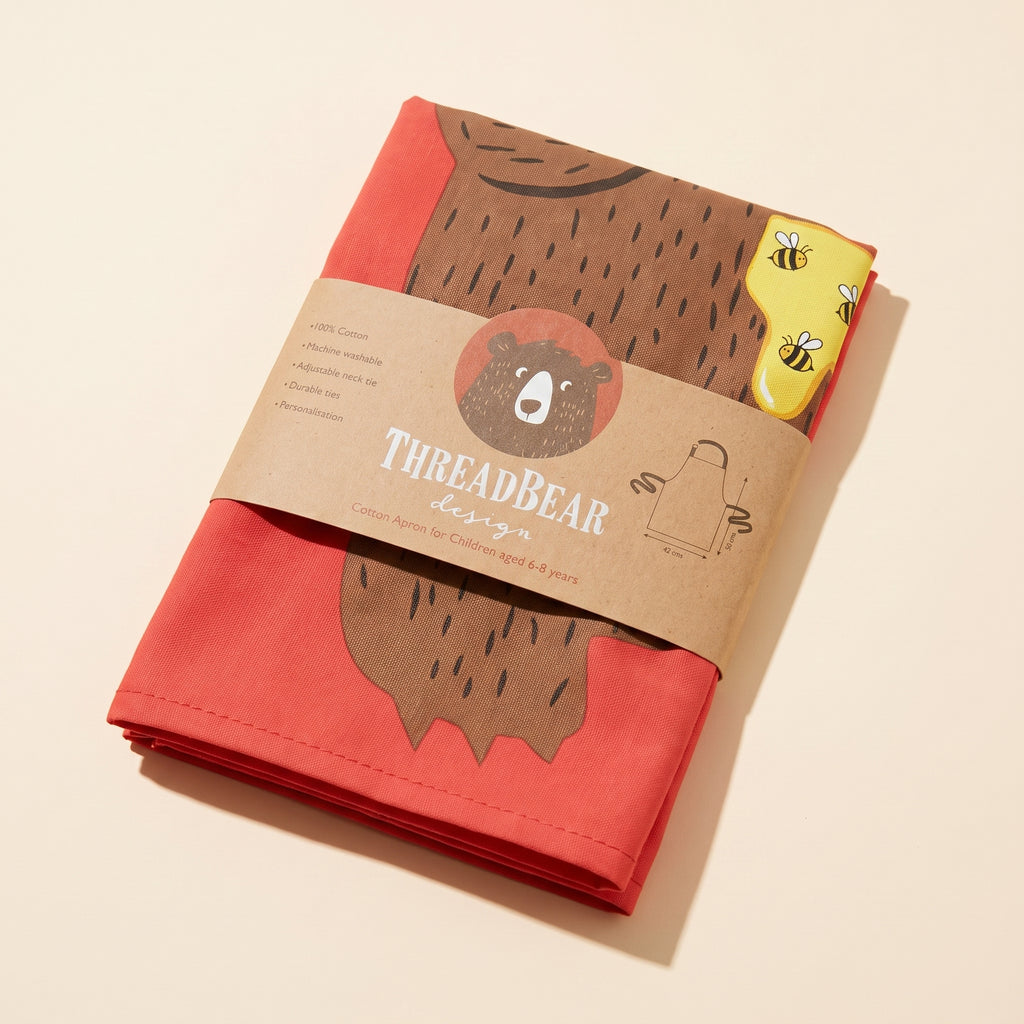 Threadbear Design red cotton children's apron with bear print, kraft band packaging